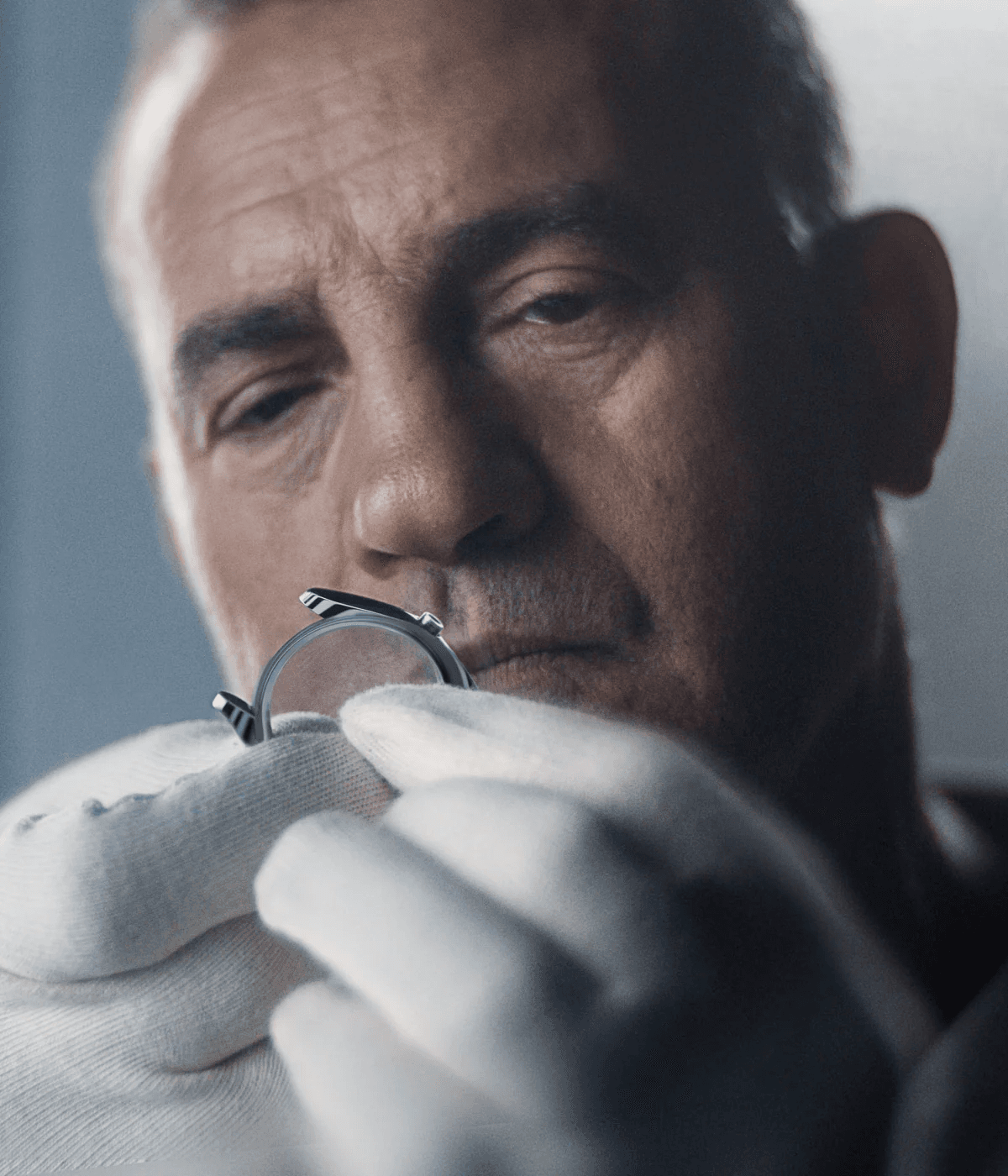 Man inspecting Watch while White Rubber Gloves